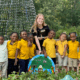 Experience UGA volunteer posing with 10 CCSD students