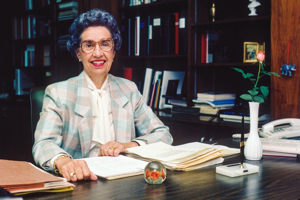 Environmental portrait of Louise McBee sitting at her desk in her office.