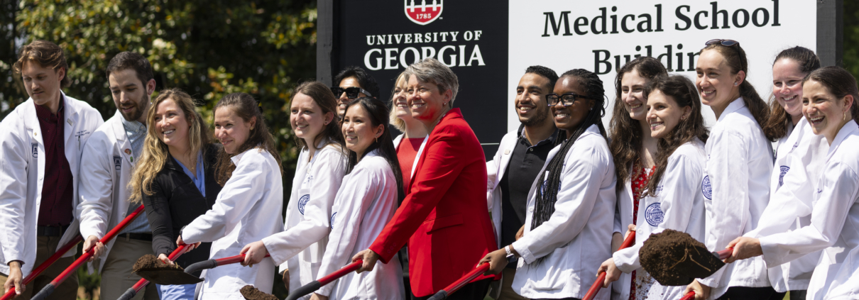 Founding Dean of the School of Medicine Shelley Nuss, middle, poses for photos and turns dirt with current medical students at the groundbreaking ceremony for UGA’s Medical Education and Research Building in Athens on April 19, 2024.