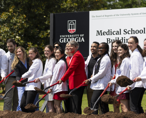 Founding Dean of the School of Medicine Shelley Nuss, middle, poses for photos and turns dirt with current medical students at the groundbreaking ceremony for UGA’s Medical Education and Research Building in Athens on April 19, 2024.