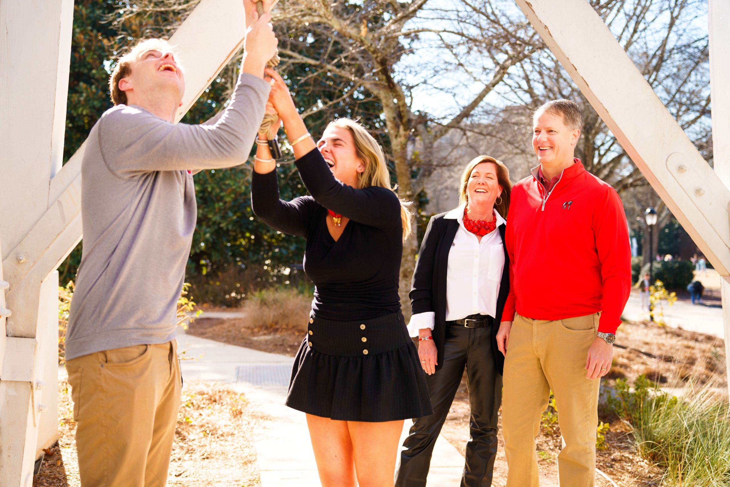 Stephanie (BSFCS ’94) and Fielder Shurling look on while their children Hunt ‘26 (Left) and Calder ‘28 (Right) ring the iconic UGA Chapel Bell. (Photo/Lilli Sosbee)