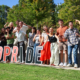 Group of smiling students by "ADPRIDE" letters.