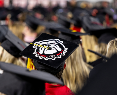 A Bulldog design is featured on a graduation cap.