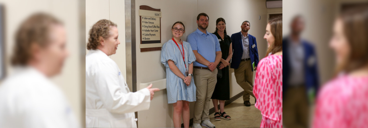 Cassidy Head is picture in a hallway with rural health care workers during her internship with the UGA Archway Partnership.