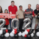 Six Destination Dawgs participants pose with celebratory balloons denoting their graduation in 2026.