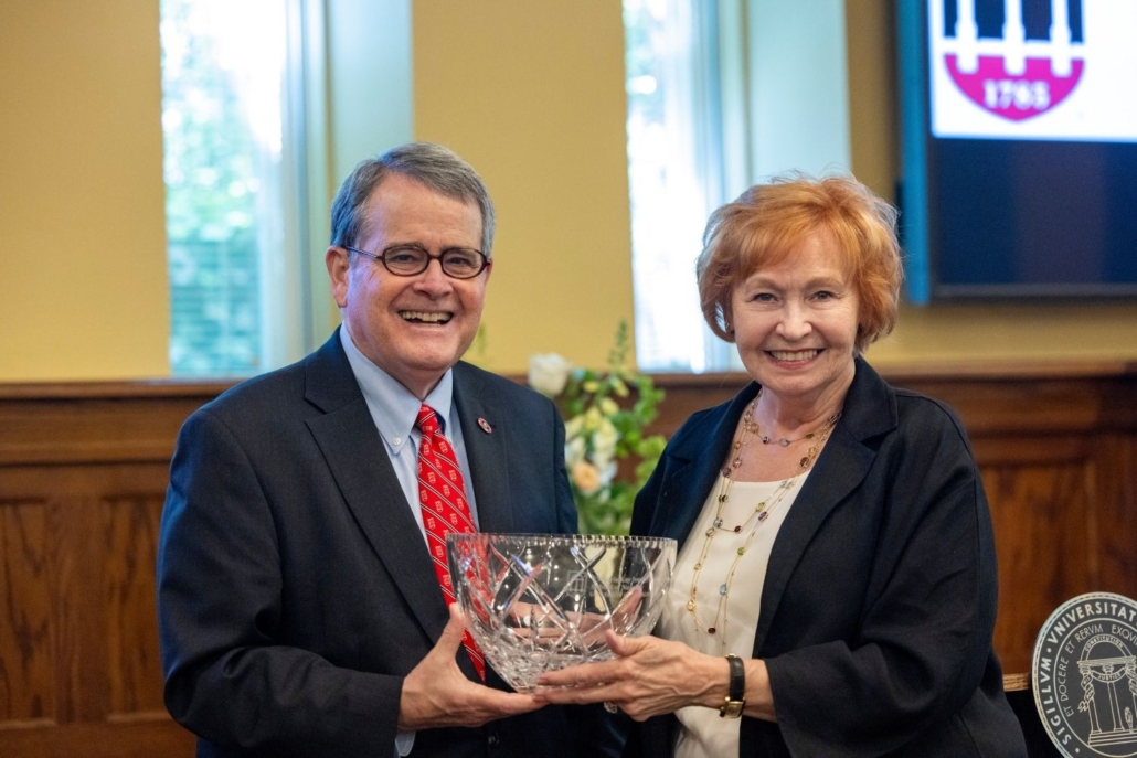 Picture of President Morehead presenting Kay Ivester with an engraved bowl.
