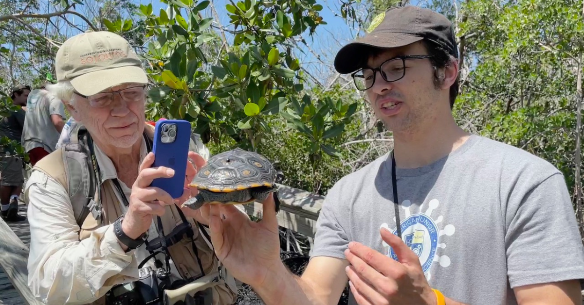 ECOL Turtle Funder Header student with turtle