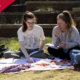 photo of social work students studying on the lawn