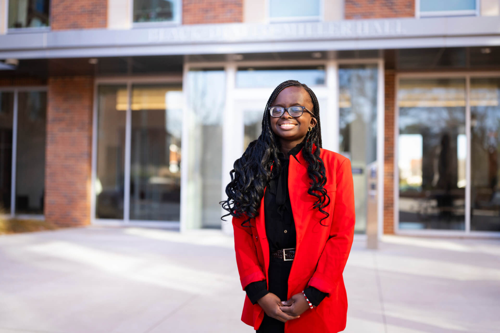 Fatime Niane, recipient of a UGA need-based scholarship, in front of Black-Diallo-Miller Hall