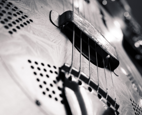A closeup image of vintage Gretsch guitar pictured from a downward angle in black and white. 