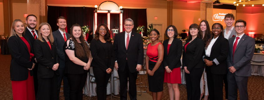 Student volunteers stand with UGA President Jere W. Morehead in the Tate Student Center Grand Ballroom before the 2022 Presidents Club Reception.