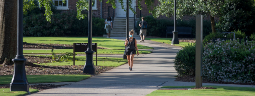 A student wears a face covering on campus.