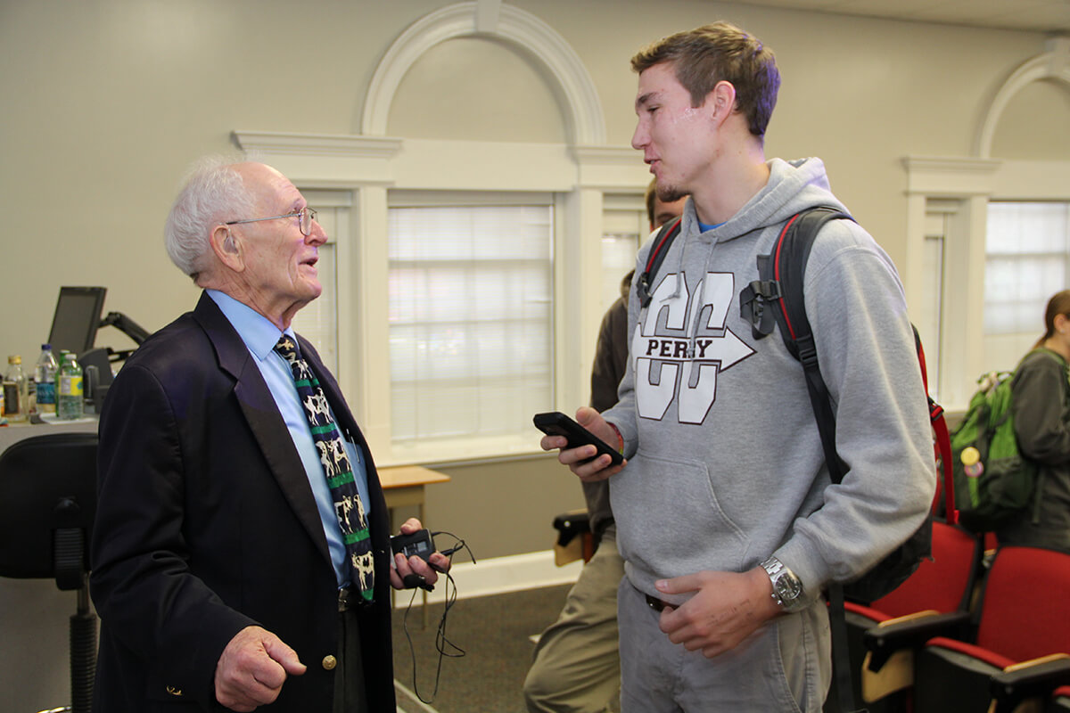 Bill Flatt speaks with a UGA student following a guest lecture in 2014.