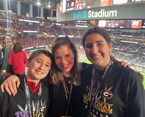 Danelle and her children pose for a photo at the 2022 National Championship football game.