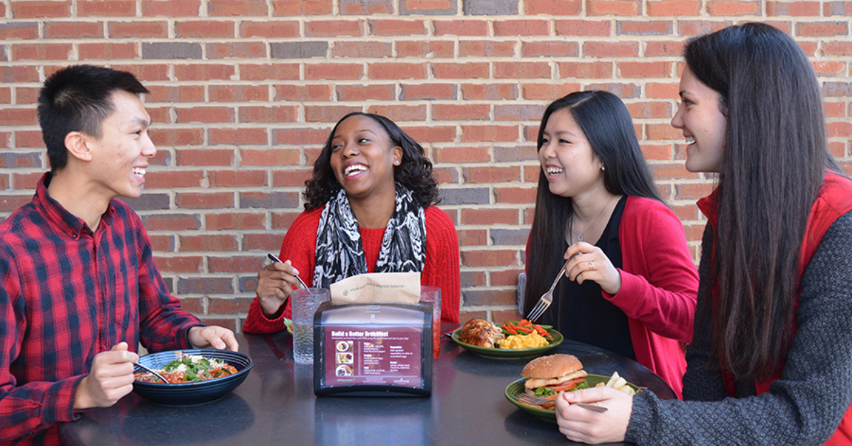 Photo of college kids eating at a table
