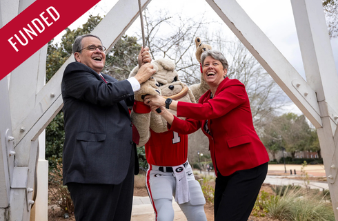 President Morehead and Dean Shelley Nuss ringing the Chapel Bell with Hairy Dawg.