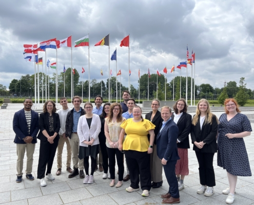 Global Externship students pose in front of a NATO building