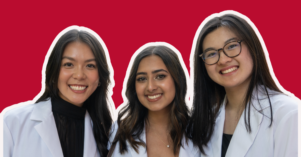 students smiling in white coats