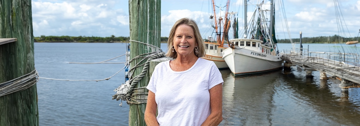 Ruth Bartlett stands on a dock before embarking on a horseshoe crab trawl with UGA Marine Extension. Photo: Trey Cooper