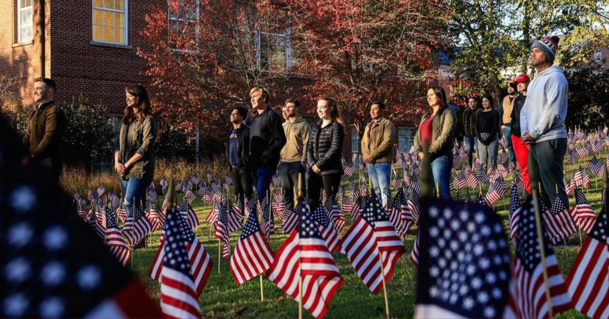 photo of UGA cadets standing amongst a field of American flags