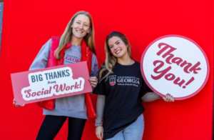 photo of two students with thank you signs