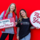 photo of two students with thank you signs