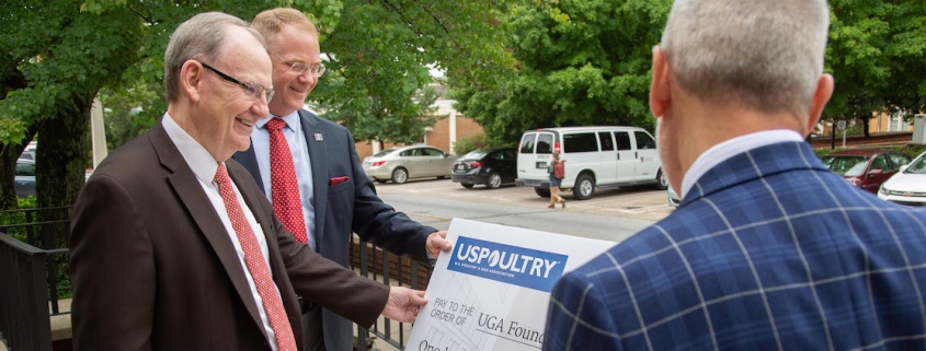 USPOULTRY President John Starkey (center) talks with Department of Poultry Science Head Todd Applegate (left) and CAES Dean Nick Place